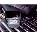 The valve cover is located at the front of the engine near the oil dipstick
