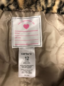 Labels for the recalled Cheetah Fur Jacket for infants.