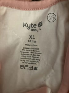 Neck label showing "Kyte Baby" brand, size, and "Made in China"