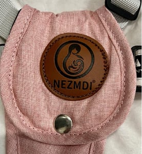 A leather patch with the brand Nezmdi located on restraints
