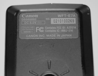 The serial number is on a gray metallic plate on the bottom of the unit