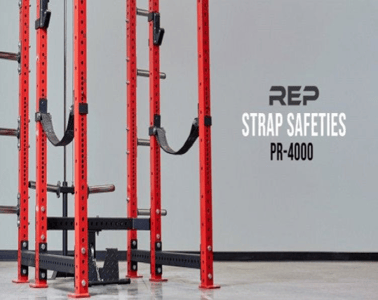 PR-4000 Strap Safety Brackets attached to the weight lifting posts of a squat stand