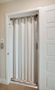 The door to the elevator generally matches all other doors in the home. The elevator gate may be open metal lattice or a solid folded sliding door.