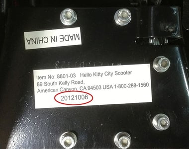 The model number and the manufacture date are printed on a label on the underside of the scooter