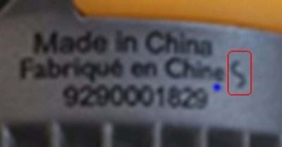 The factory code, a slanted “S,” and other information printed on the ceramic band on the neck of the bulbs.