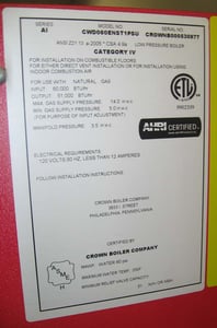 The model number and the manufacturing date are located on a white rating label located on the upper right side of the boiler.