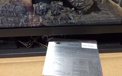 The testing label is next to the gas valve of the fireplace or fireplace insert.