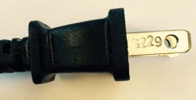 Location of code on plug blade