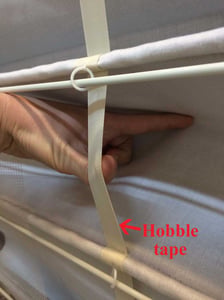 Strangulations can occur between the exposed “hobble tape” (ribbon) and the fabric on the backside of the shade.