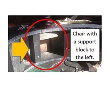 Chair with a support block to the left.