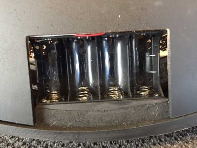 Golda Wall Clock with defective battery springs located at the bottom of the battery compartment.