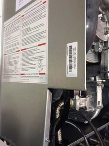 Location of serial number under white cover