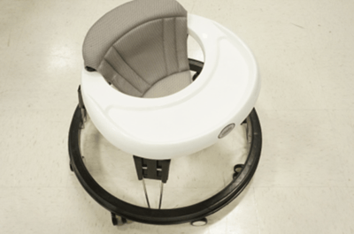 Recalled Zeno infant walker with black frame, gray seat and white tray