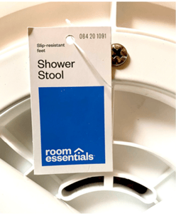 The Room Essentials logo and item number 064-20-1091 are printed on the front of the recalled shower stool's hangtag.