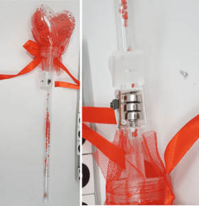 Recalled light-up heart balloon flower (Item No. 777-1) – Wand and close up showing accessible button cell batteries.
