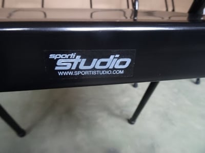 The label (positioned on the back of the seat) of the recalled Sporti Studio branded version of the Spiraledge Everyday Yoga Backless Yoga Chair.
