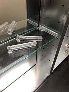 One-piece bracket system for inner shelves on recalled medicine cabinets