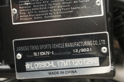 The youth ATV's model number appears on a plate located at the front of the vehicle between the two front tires