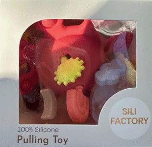 "Sili Factory" and "Pulling Toy" printed on the front of the recalled teething toy packaging