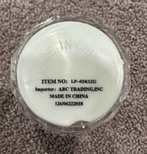"ITEM NO: LP-024 (122)" and "Importer: ABC Trading, Inc" are printed on a label on the underside of the recalled shot glasses