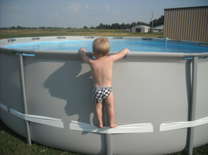 Example of child using the compression strap to stand on above-ground pool, illustrating the hazard involved